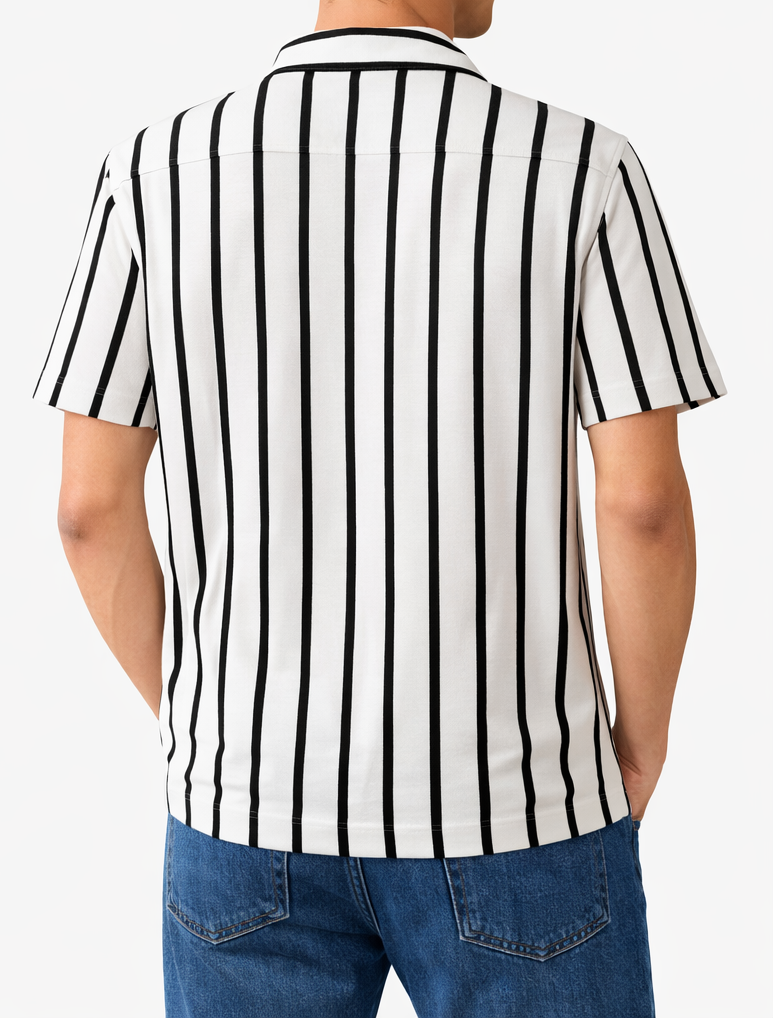 Person wearing a black and white striped shirt with blue jeans on a white background
