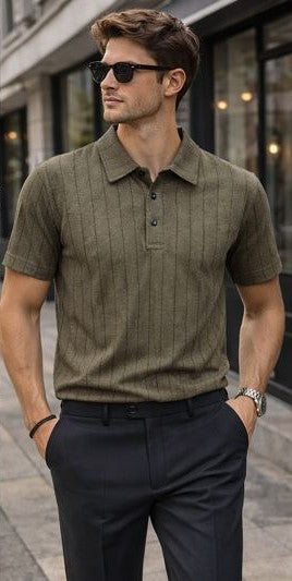 Man wearing a brown textured polo shirt and dark pants on a city street.